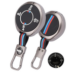 Two car key fobs with retractable straps on a white background