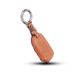 Brown leather key cover with metal ring on a white background