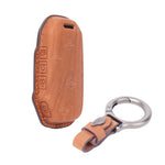 Brown leather key case with a keychain on a white background