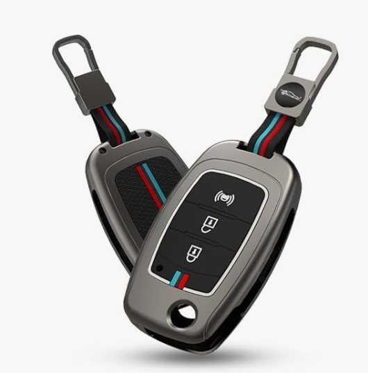 Metallic car key fob cover with keychain on a white background