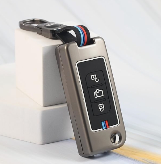Metallic key fob with buttons on a light gray background