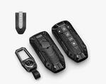 Set of black car key fobs and remote on a white background