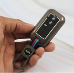 Hand holding a car key fob with buttons on a white background